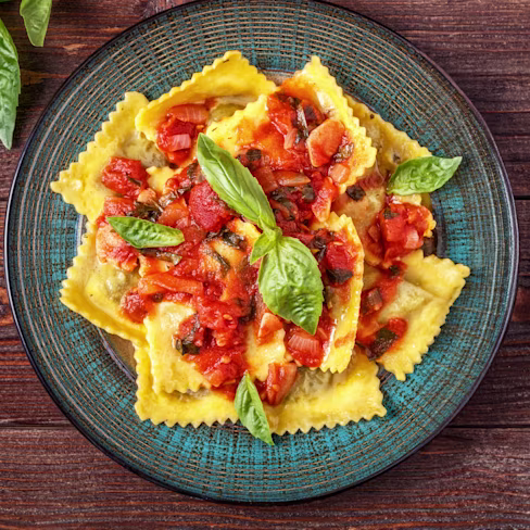 A bowl of Rana Ricotta & Spinach Ravioli with Carbonara-Inspired Sauce