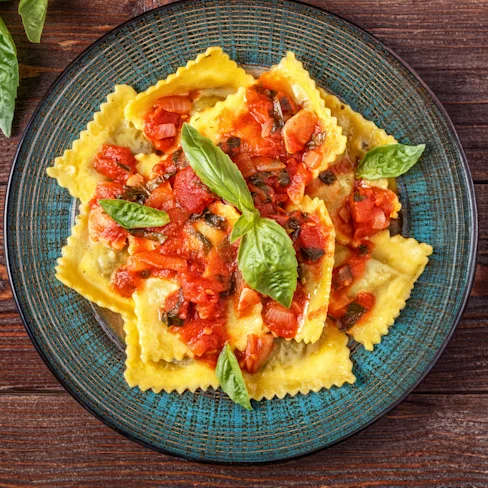 A bowl of Rana Ricotta & Spinach Ravioli with Carbonara-Inspired Sauce