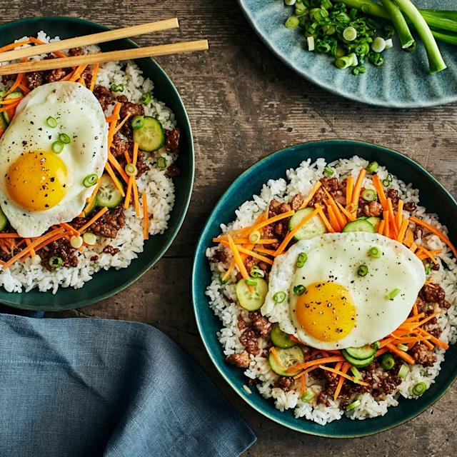 Plates of korean-style pork and rice