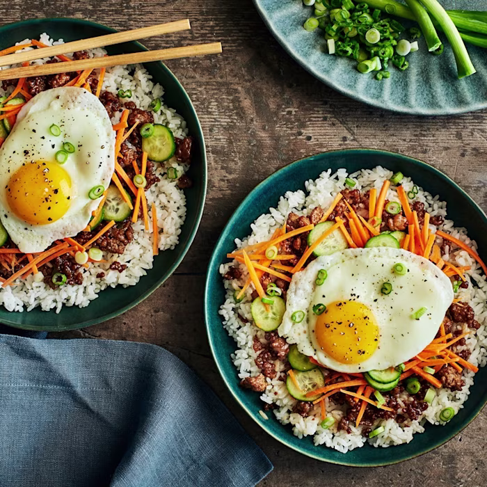 Plates of korean-style pork and rice