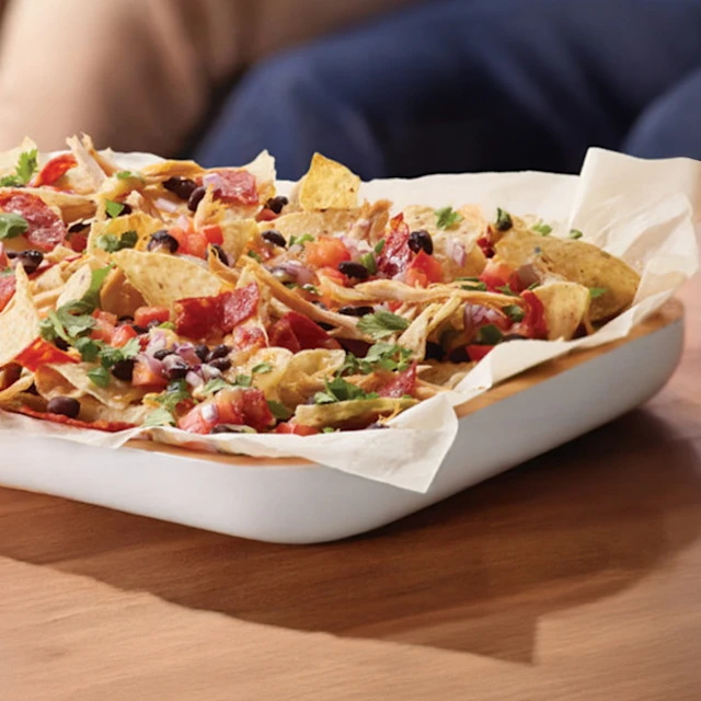 Image of a plate of smoked gouda, chicken & chorizo nachos