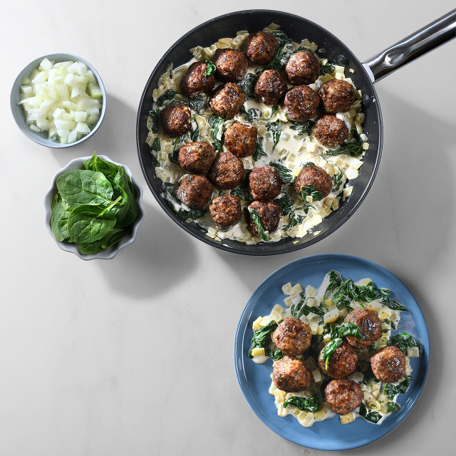 Plates showing meatballs and creamy spinach