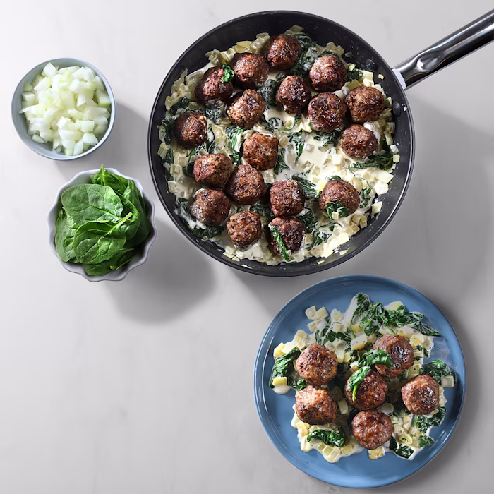 Plates showing meatballs and creamy spinach