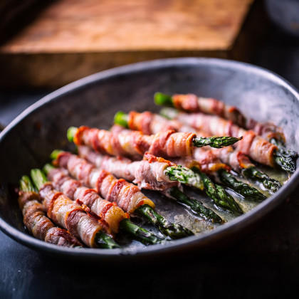 A plate of Grilled Bacon-Wrapped Asparagus
