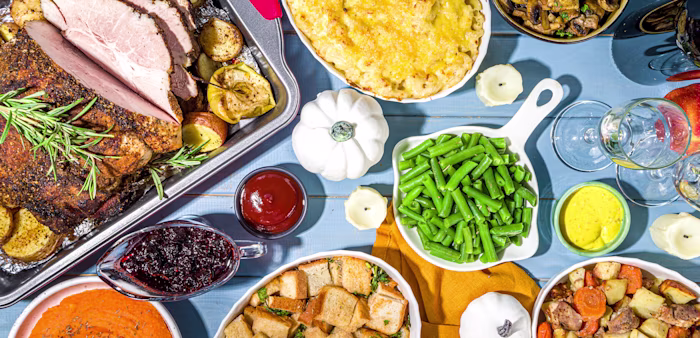 Image of Thanksgiving dinner table with pork meat, potatoes and beans