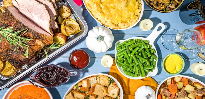 Image of Thanksgiving dinner table with pork meat, potatoes and beans