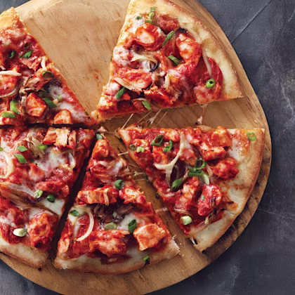 Image of butter chicken pizza slices