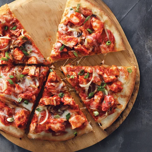 Image of butter chicken pizza slices