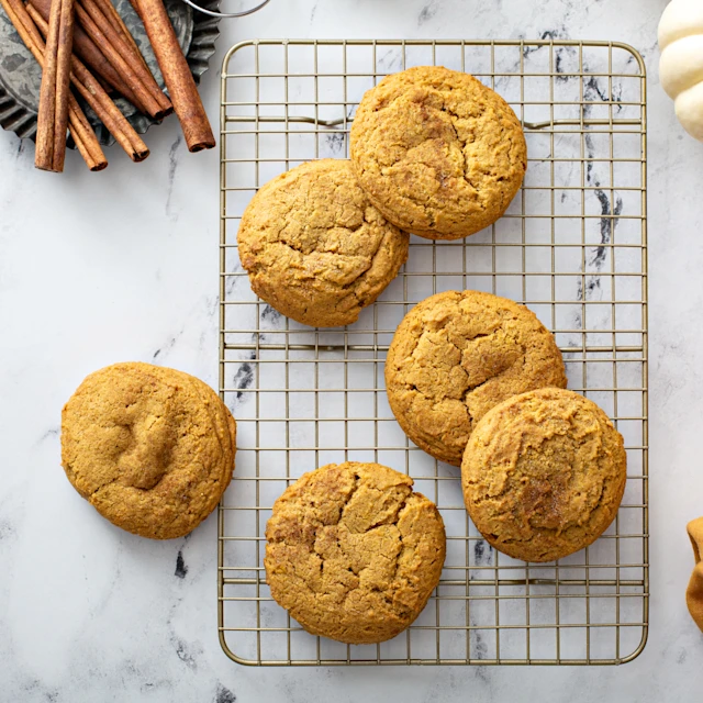 Freshly baked Soft Pumpkin Spice Oatmeal Cookies on a cooling rack