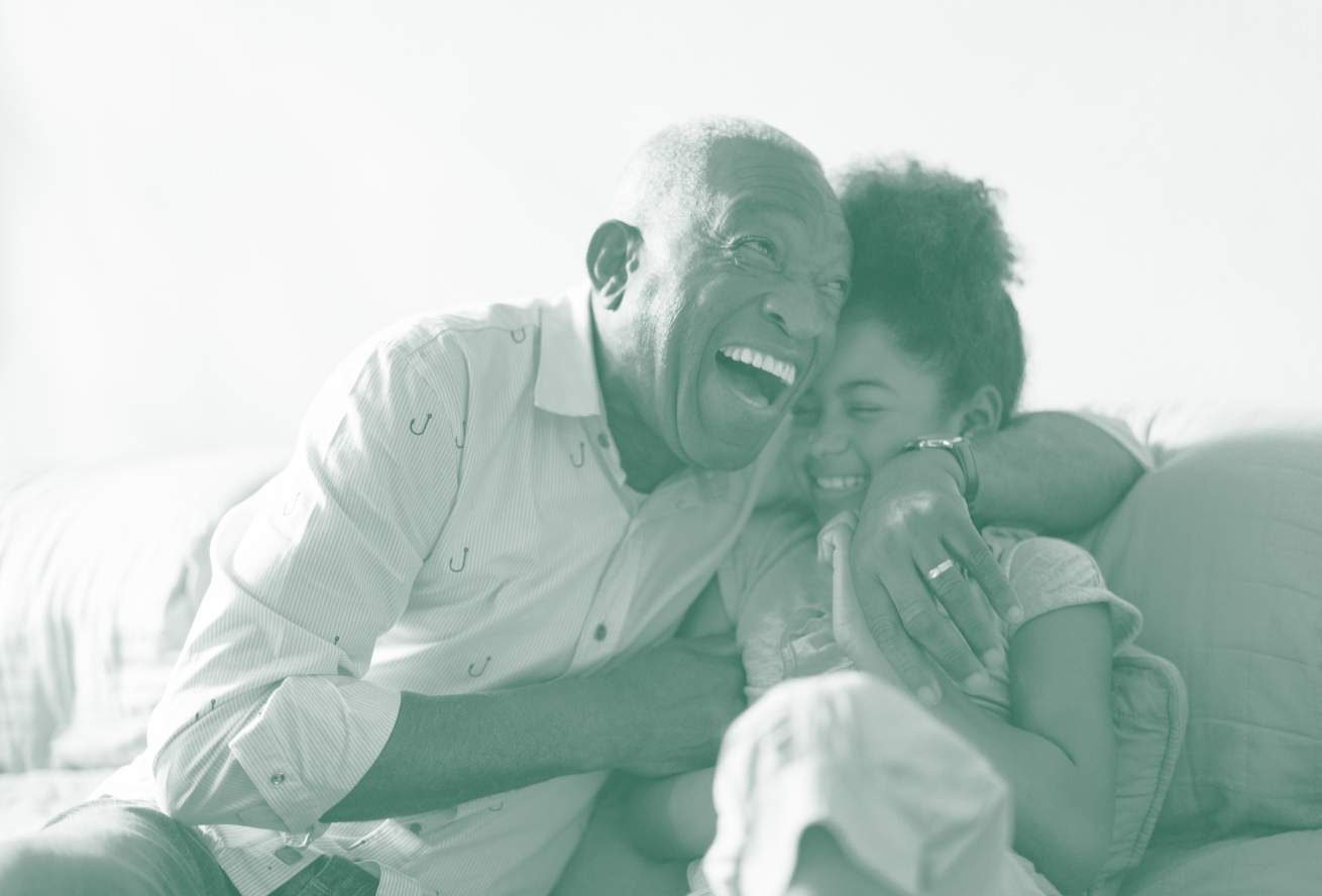 grandfather and granddaughter hugging and laughing