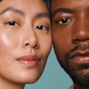 faces of two people side by side with their heads touching