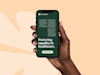hand holding iphone 10 with coral health website on screen