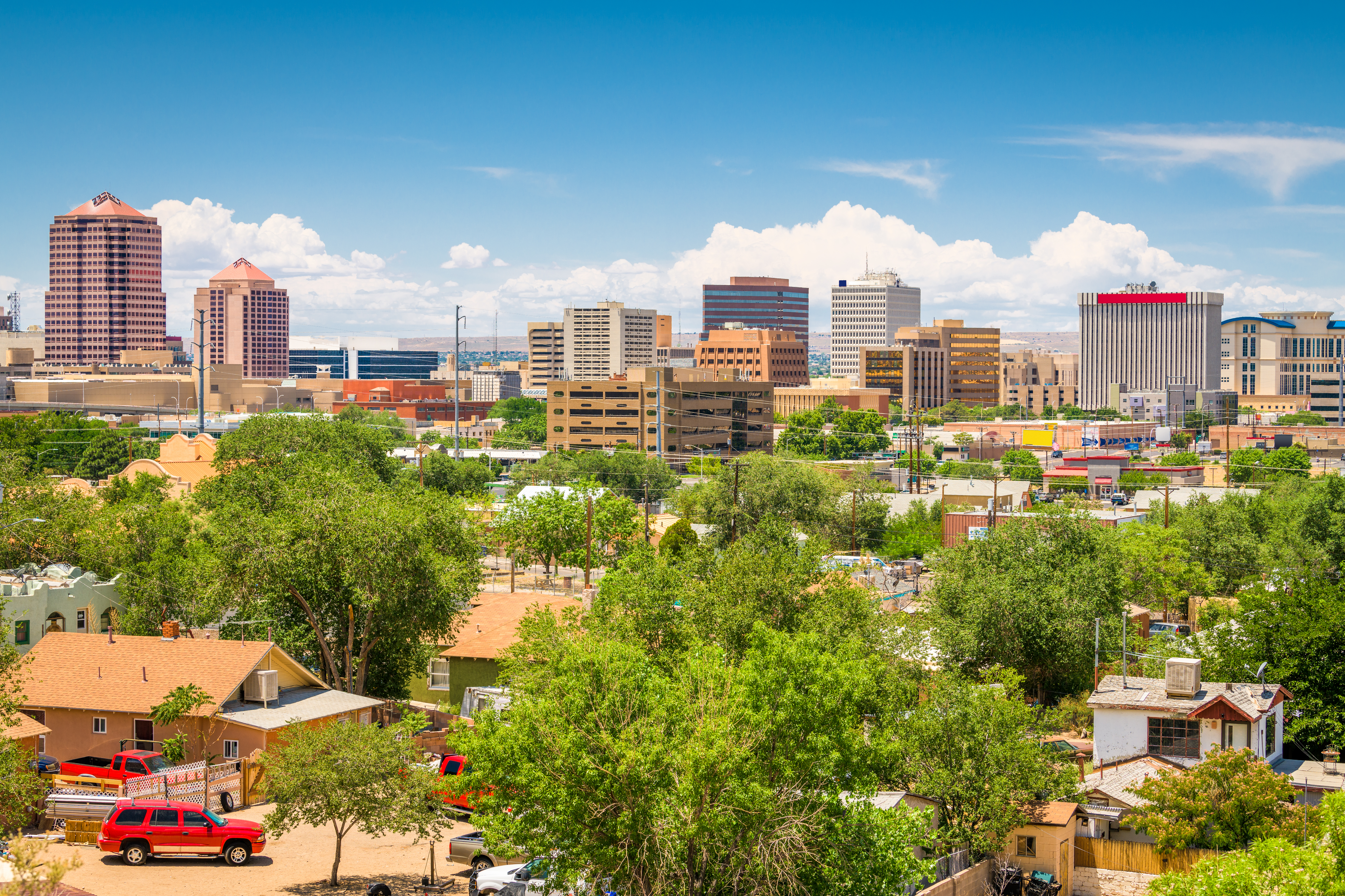 Aerial view of downtown Rio Rancho, NM with buildings and skyscrapers in the background.