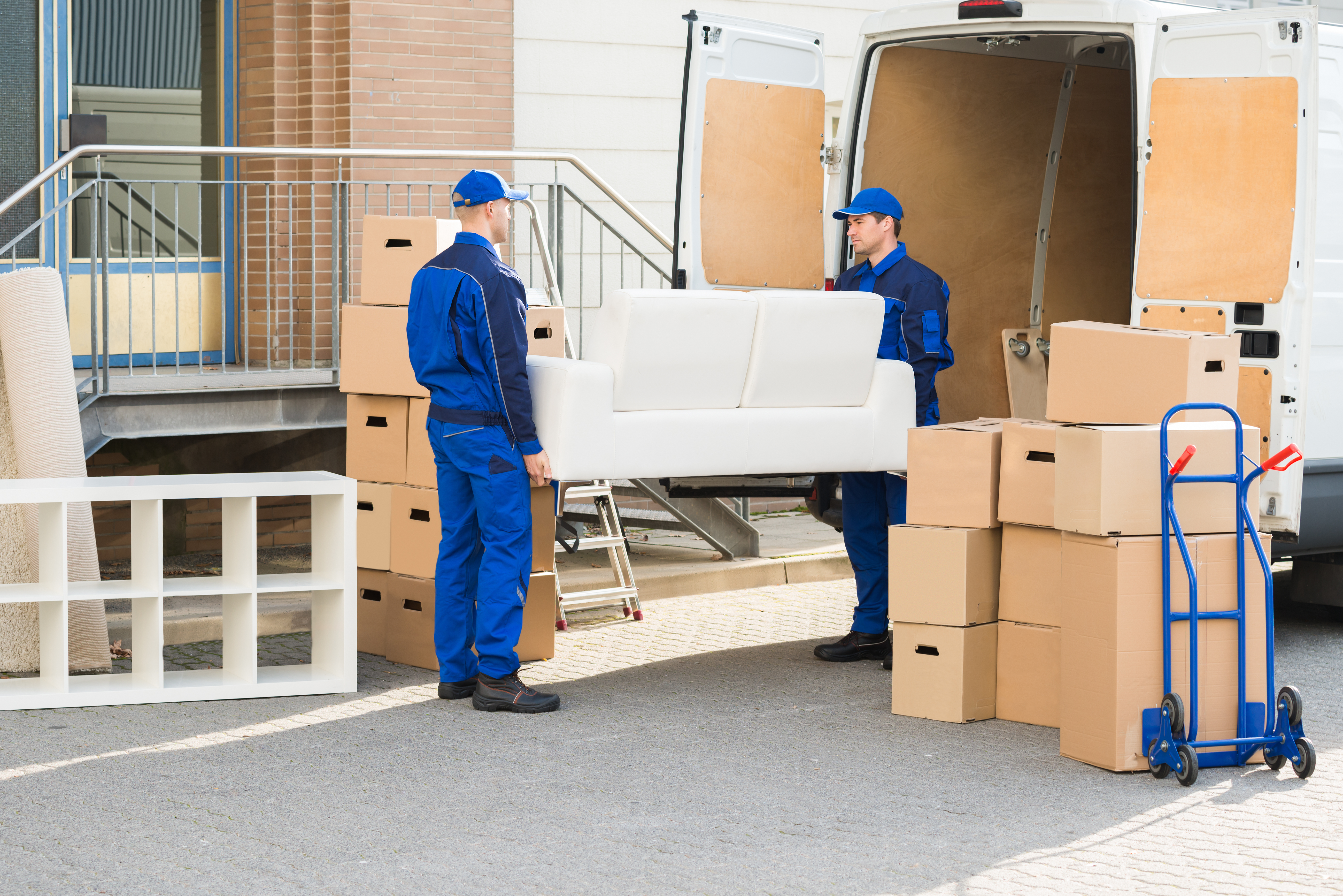 Movers carrying furniture out of a truck
