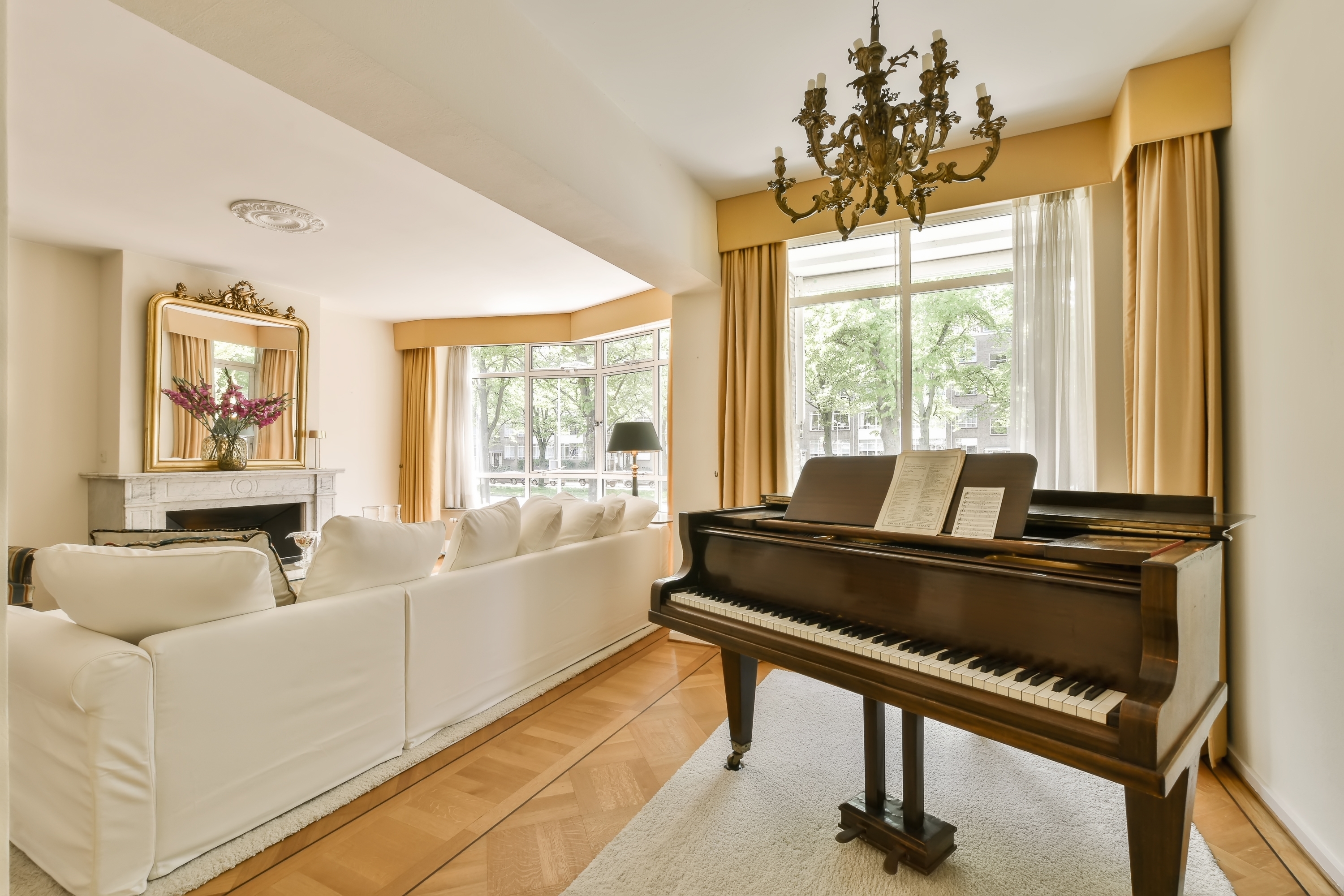 A piano in a brightly lit living room