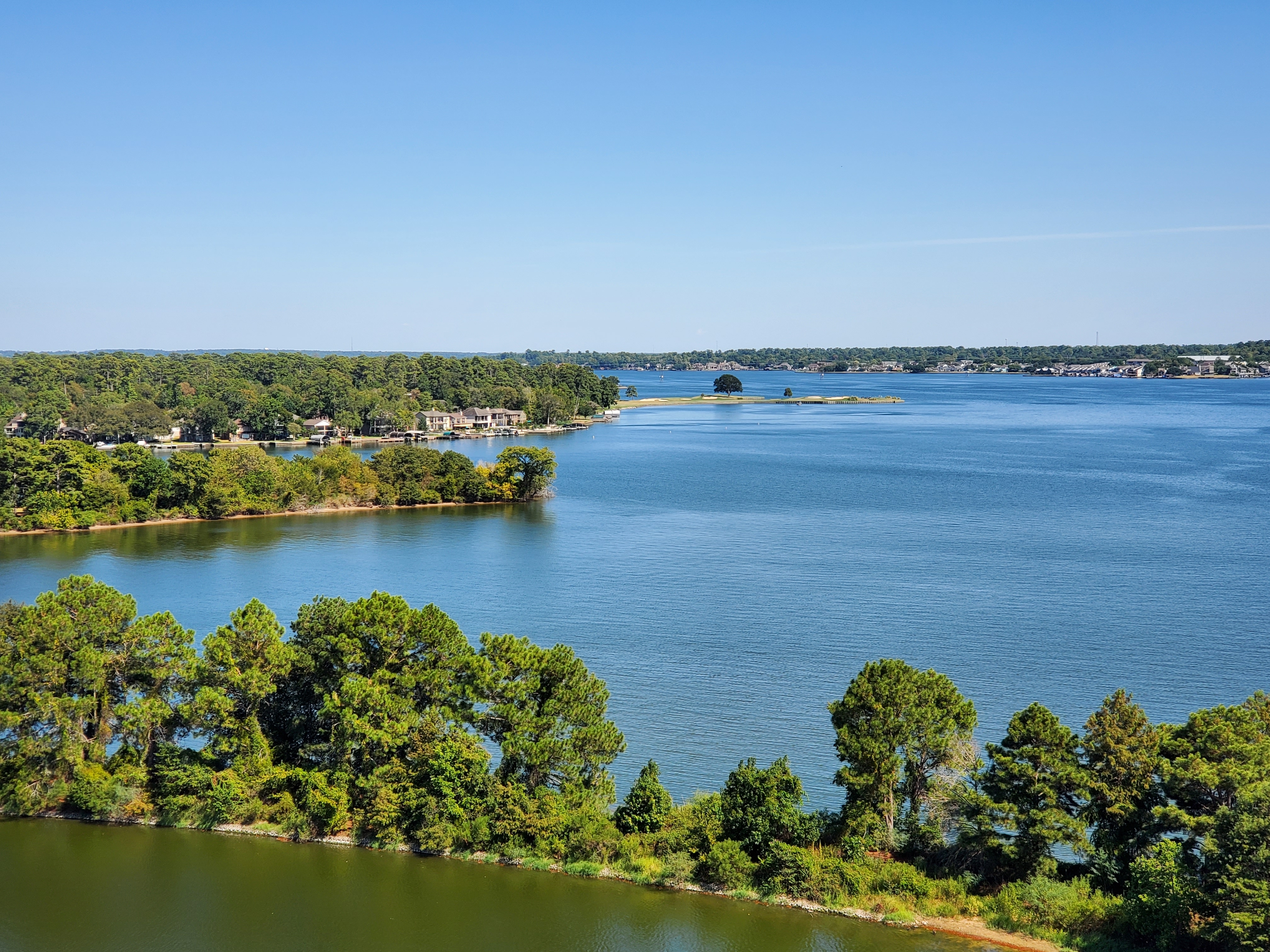 Aerial view of a lake with trees on each side.