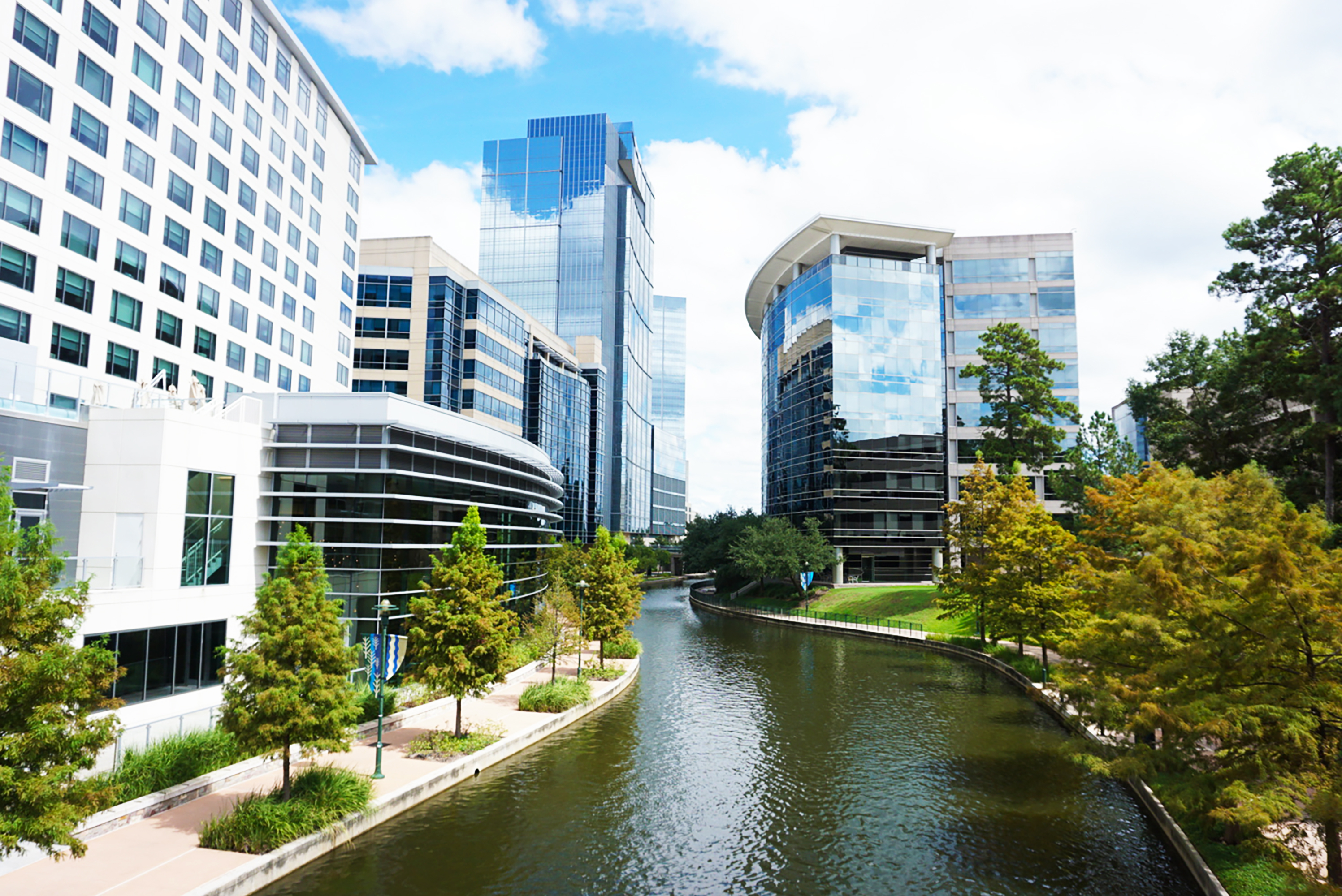 A river running through a city between buildings in Spring, TX