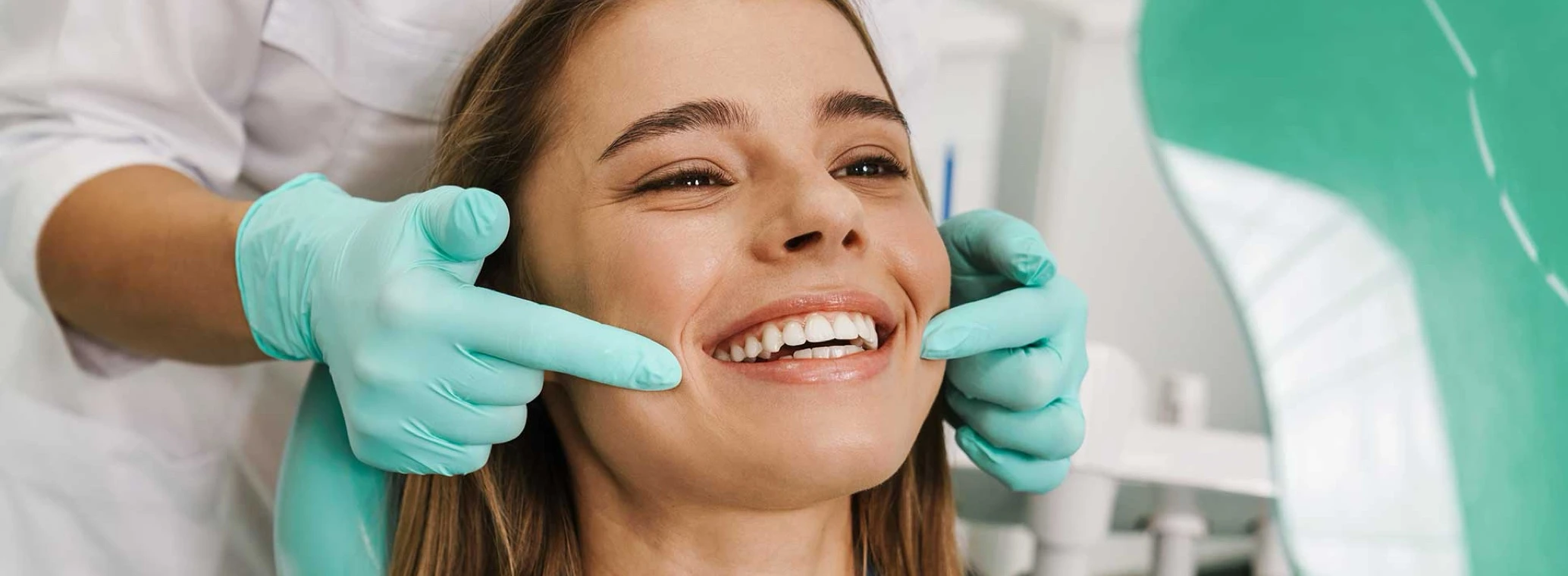 Smiling patient getting a consultation in a dentist’s chair