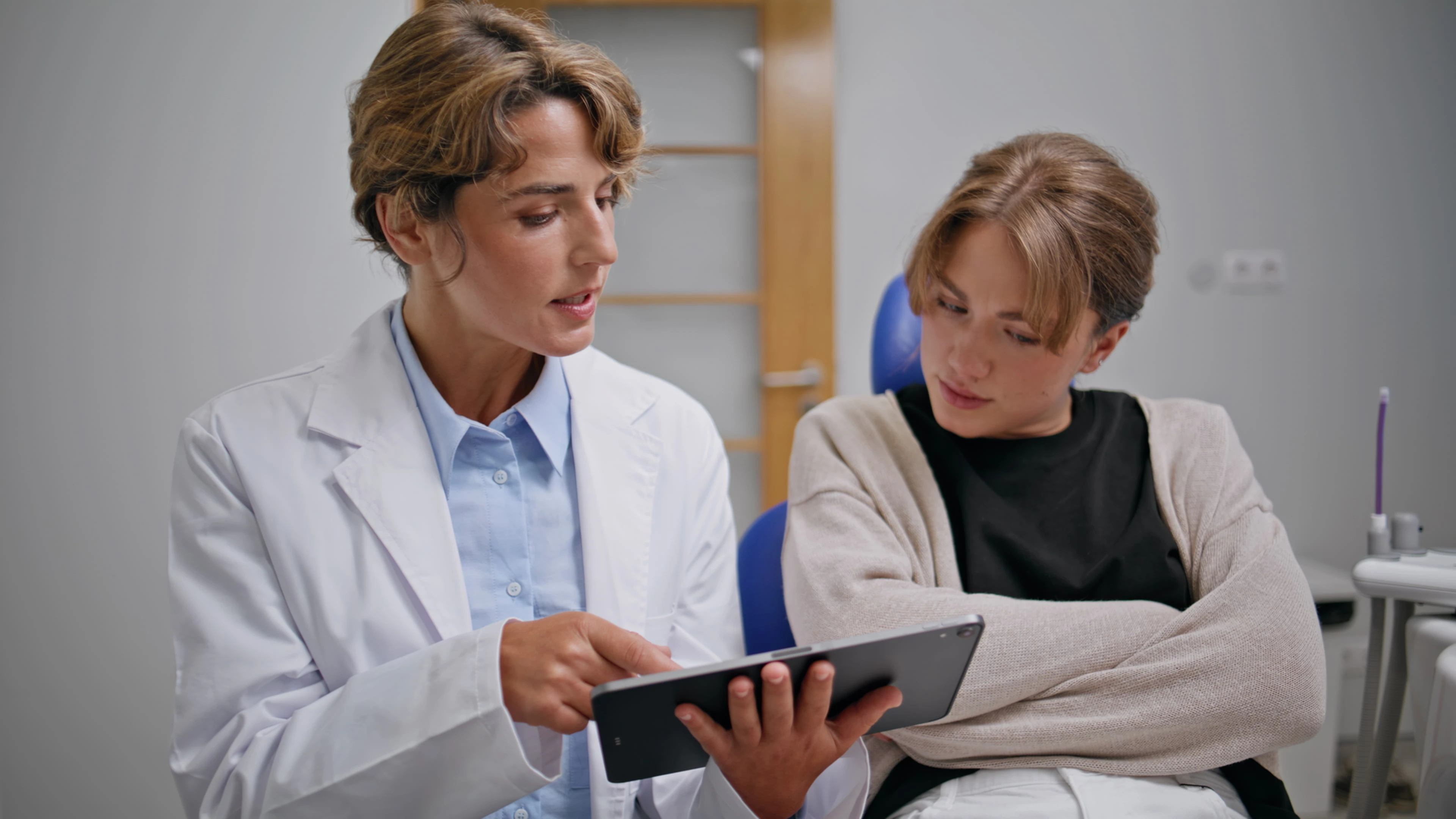 Dentist professional educating patient on oral care