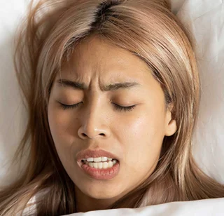 Woman sleeping and grinding her teeth