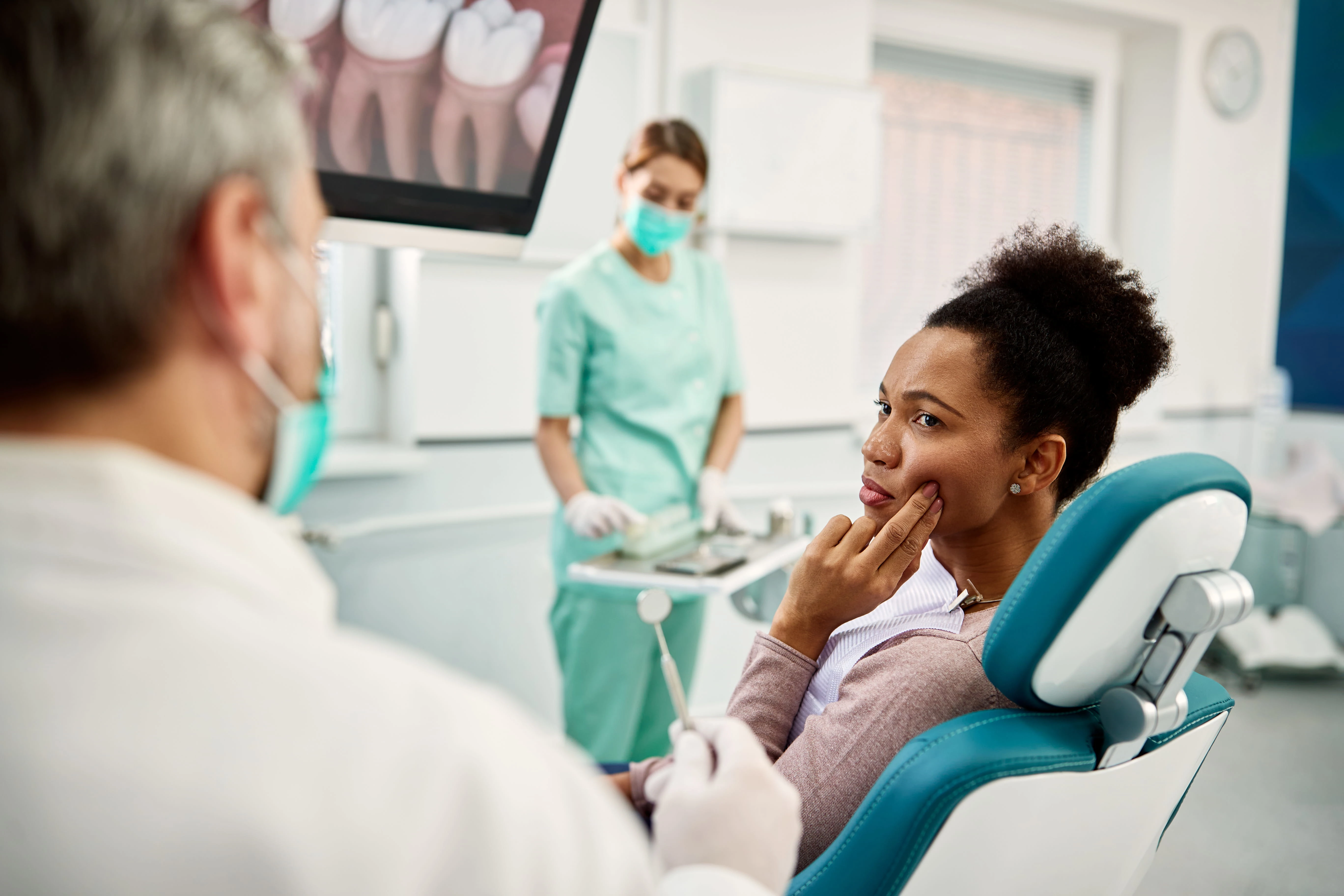 Young woman visiting the dentist for an exam 