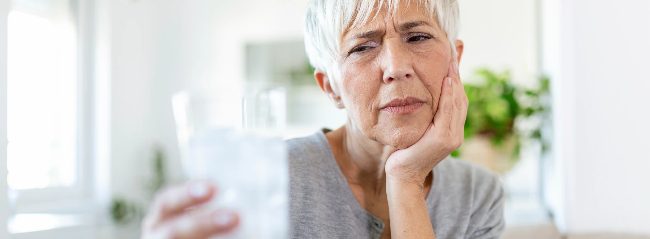 Woman holding her face in pain from a toothache 