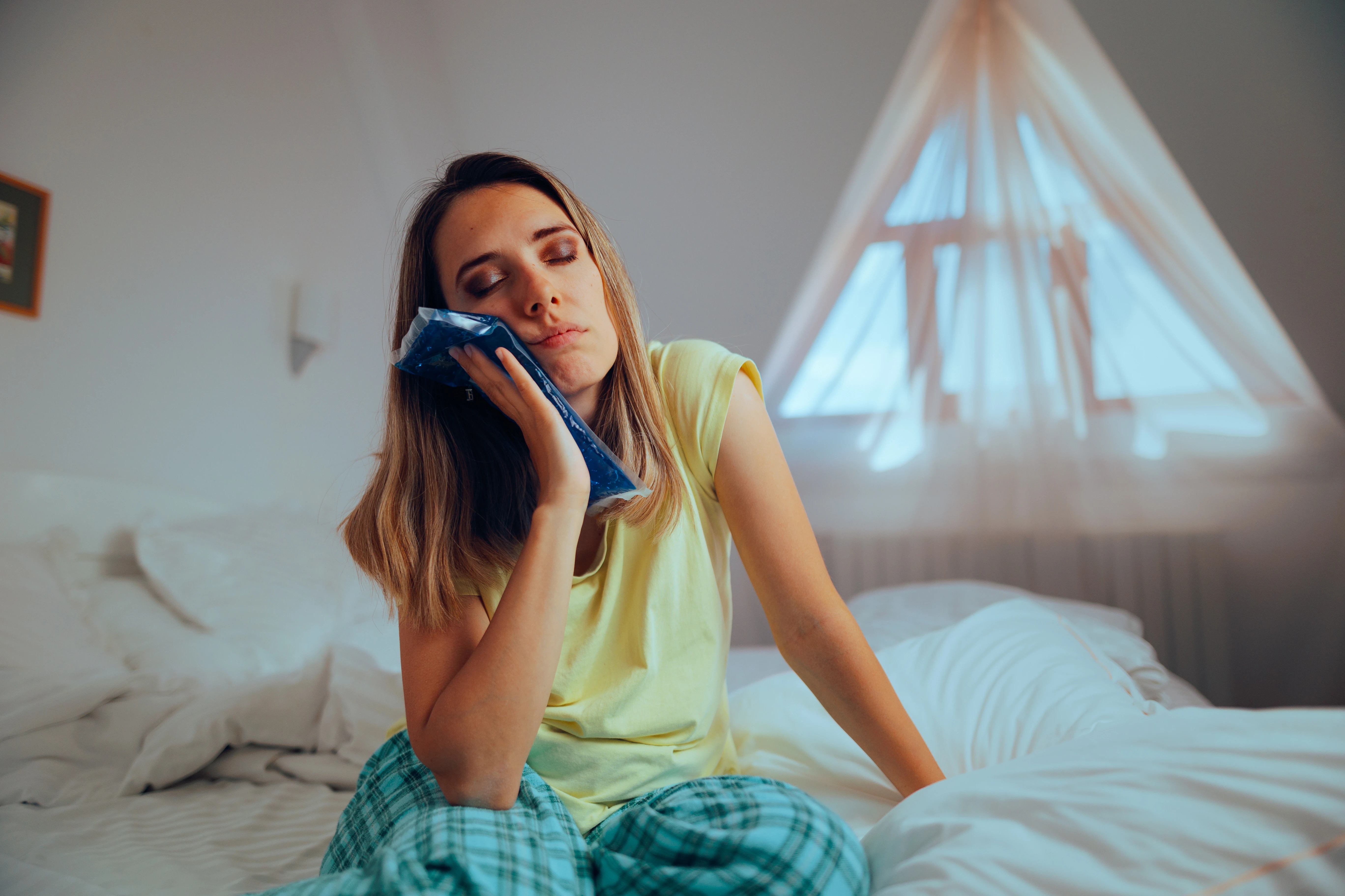 Woman holding ice pack to her jaw