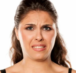 Woman grimacing due to a bad taste in her mouth 