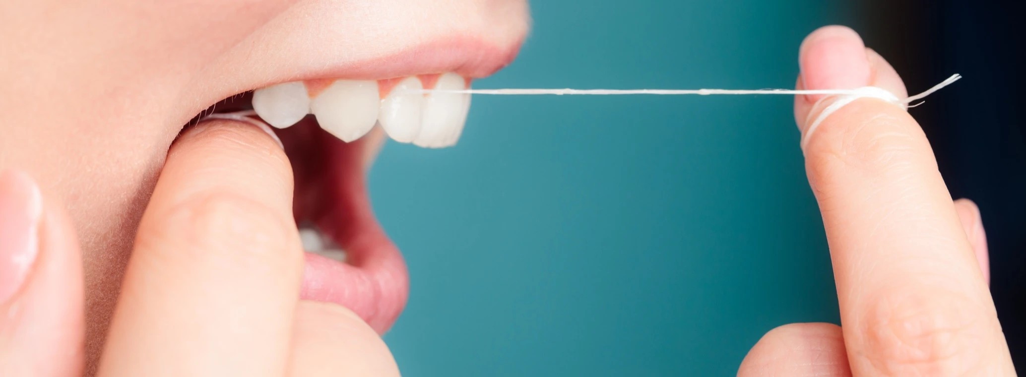 Person flossing their teeth