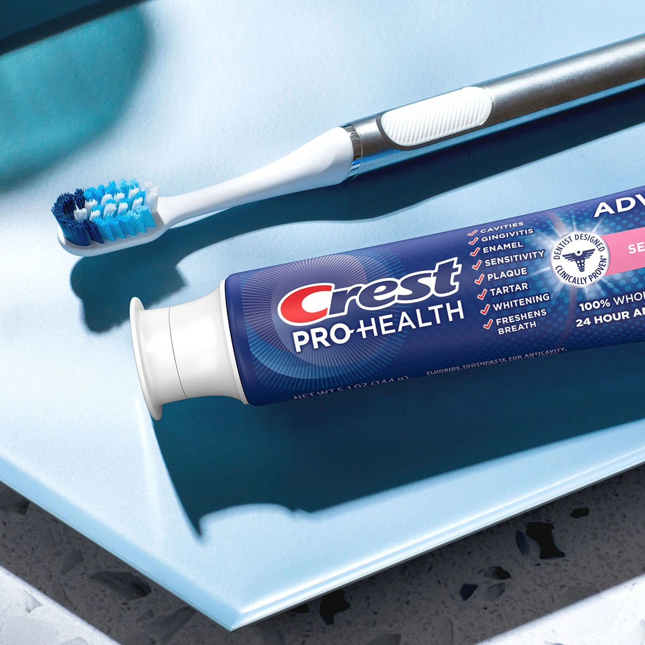 Crest Pro-Health Advanced Sensitivity Relief Toothpaste and a toothbrush on a counter