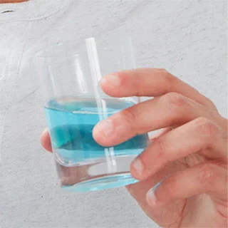 hand holding cup of mouthwash