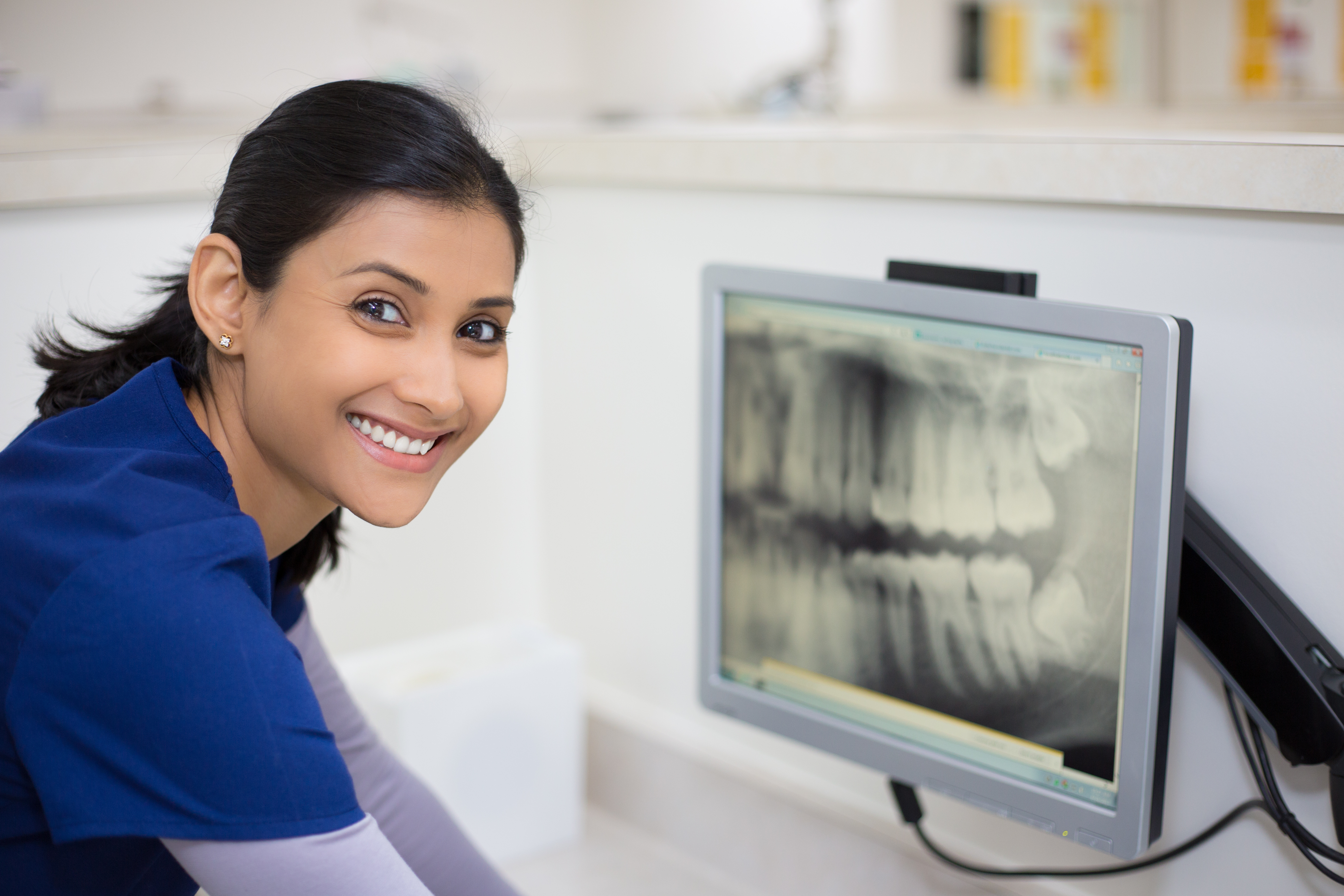 Dentist examining patient’s mouth and gums