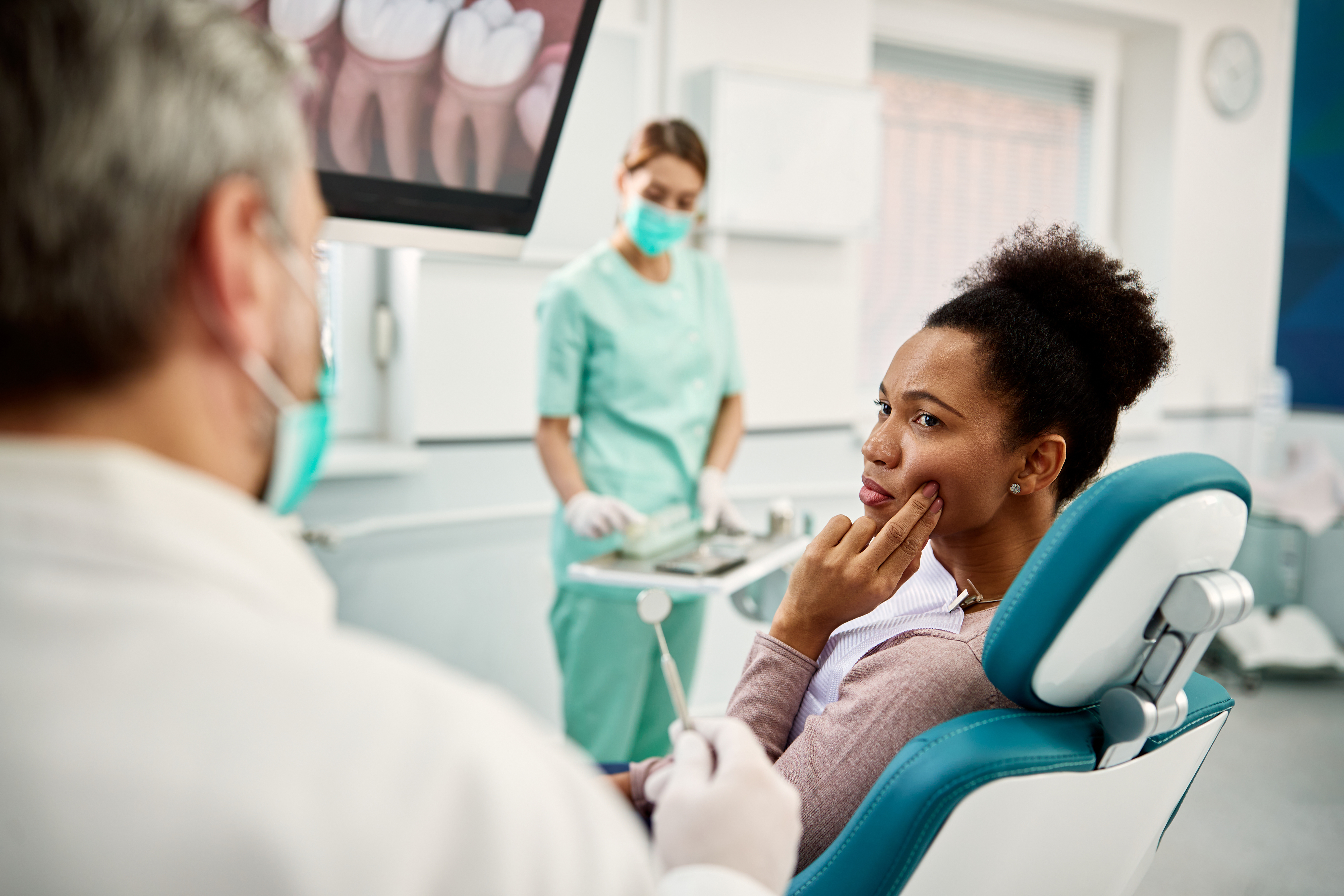 Woman sitting in the exam chair at the dentist’s office