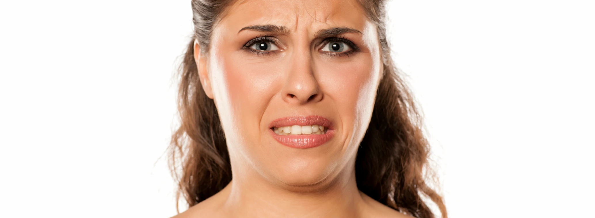 Woman grimacing due to a bad taste in her mouth 