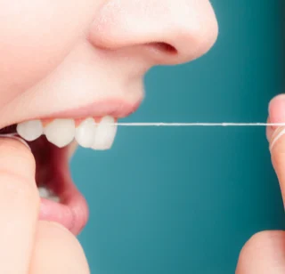 Person flossing their teeth