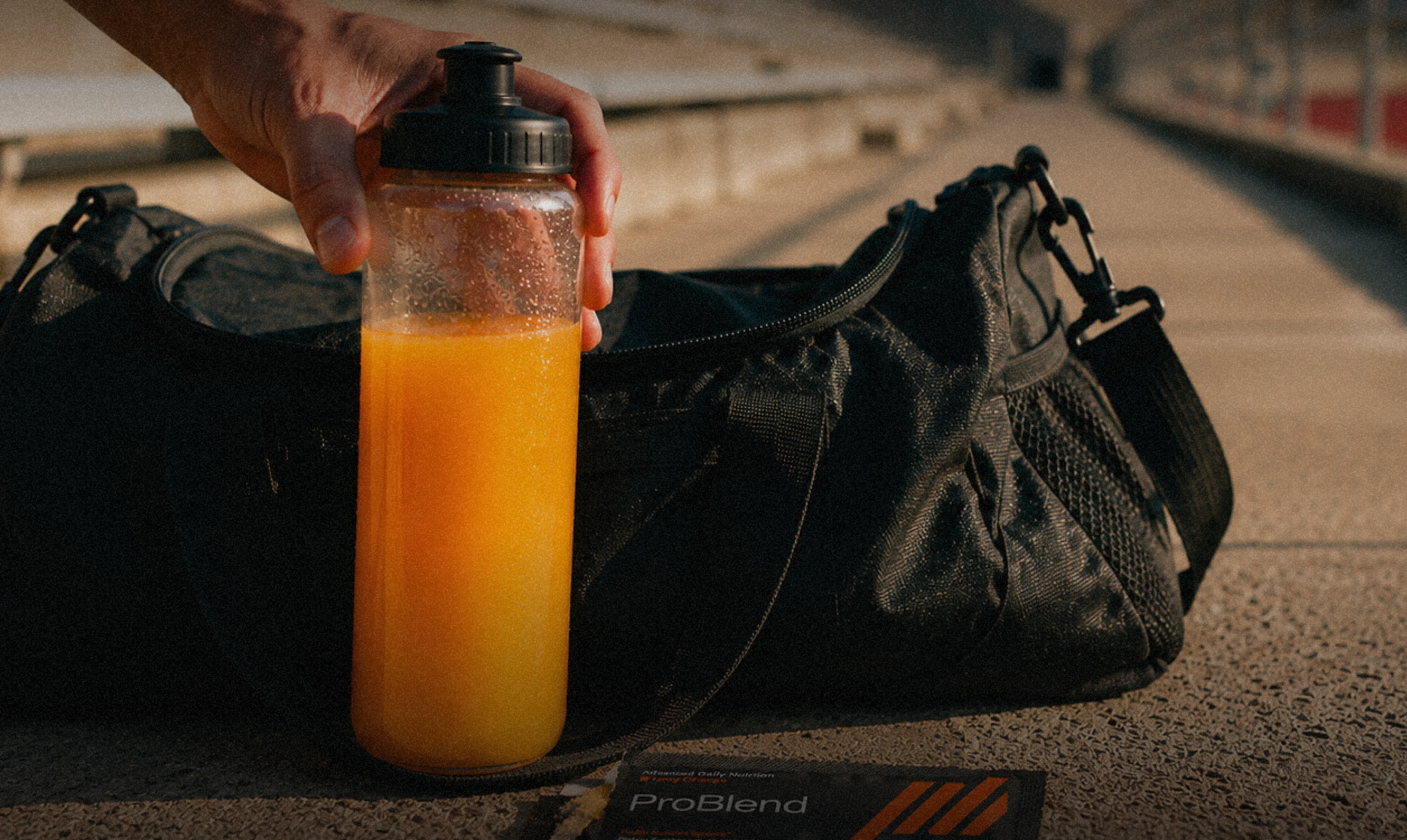Orange-colored drink in a fitness bottle