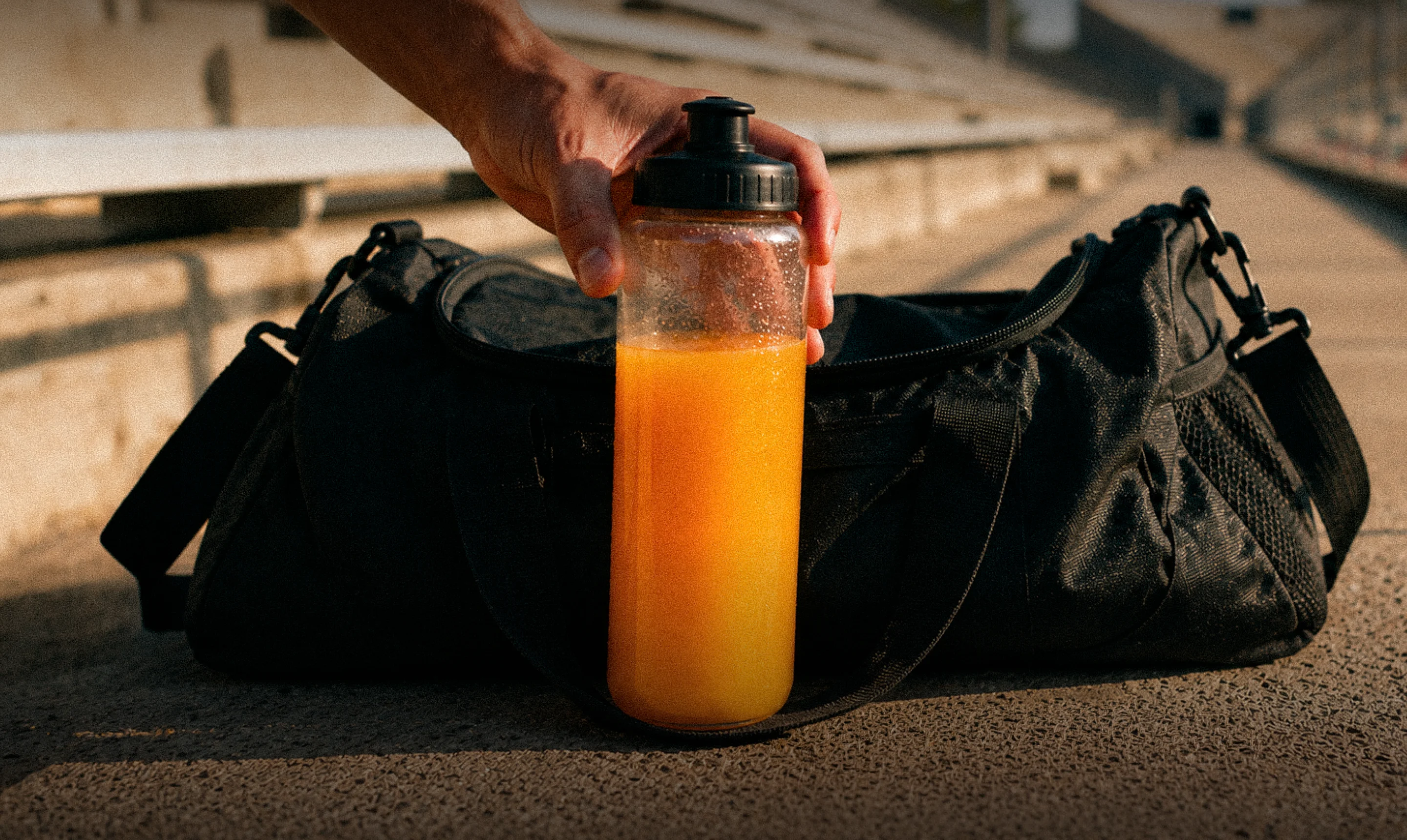Orange-colored drink in a fitness bottle