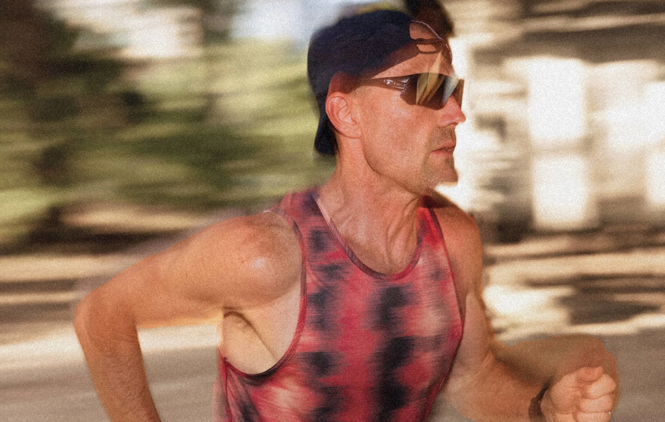 Zach Bitter running in sunglasses and a backwards hat