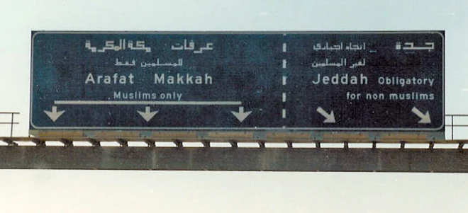 Een verkeersbord, onderweg naar Mekka. Alleen moslims mogen door, niet-moslims moeten afslaan.