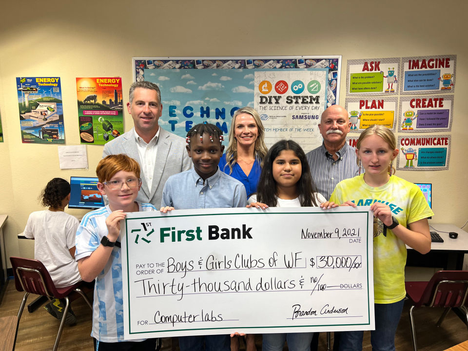 First Bank employees present a big check to children and the Boys & Girls Clubs of Wichita Falls.