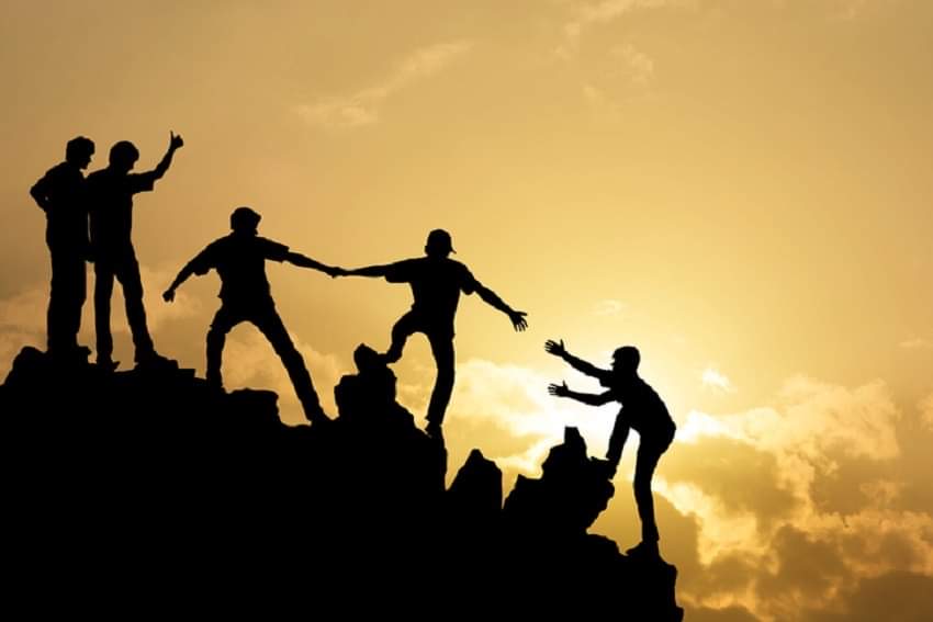 Image of people helping each other 