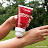 Person applying Precise Pain Relief Cream From the makers of TYLENOL to their wrist for pain relief