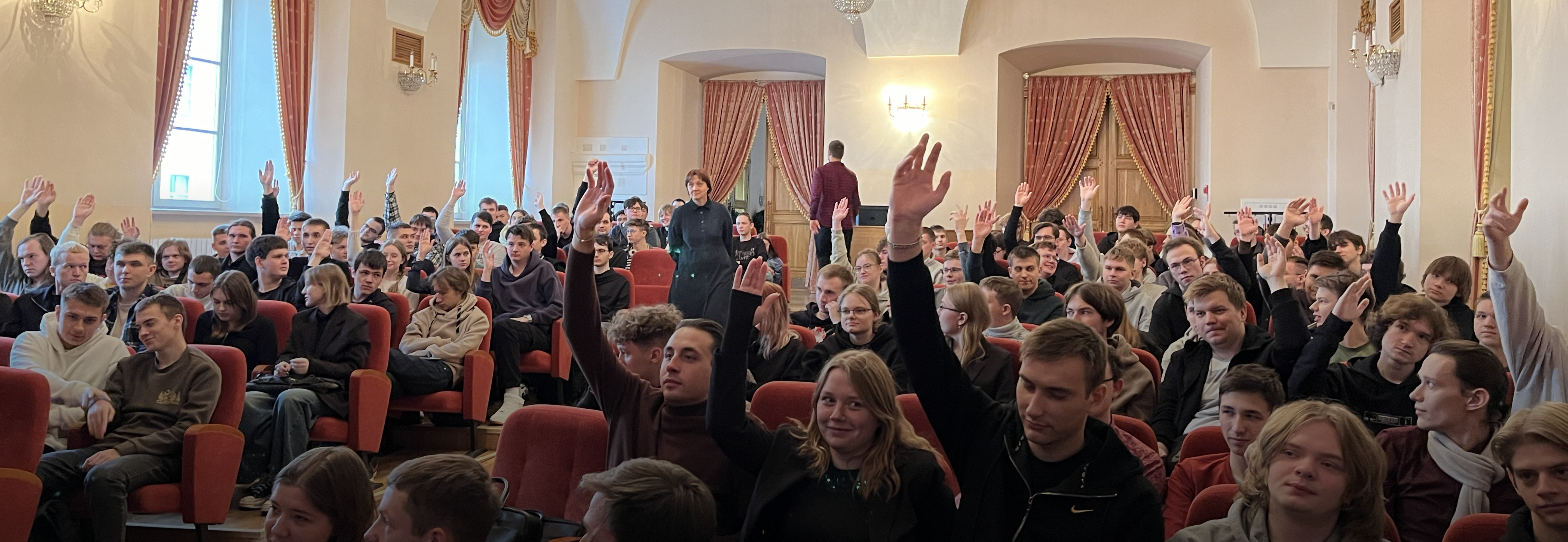 Students in the hall participate in the discussion