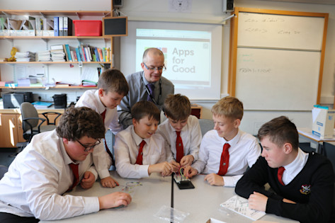 Photo - Students and teacher in classroom with IoT product