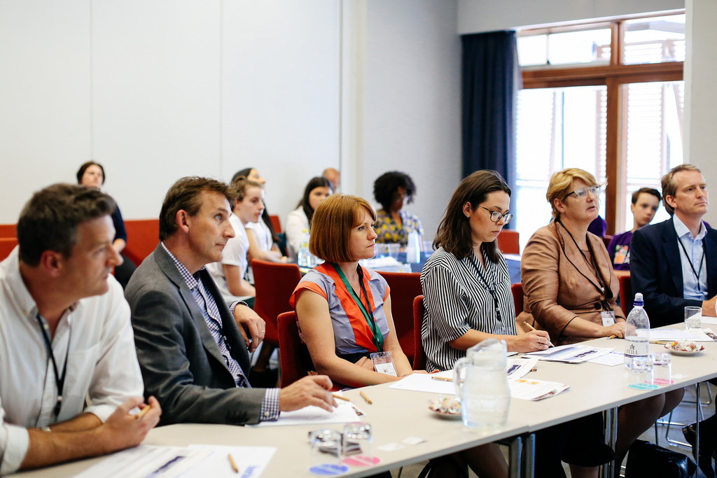 A panel of judges listening to students pitch