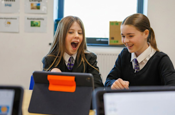 Two girls looking at a tablet