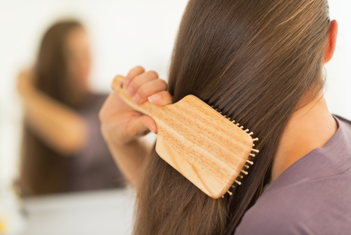 Woman with hair brush