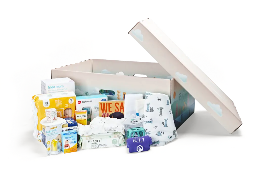 Photograph of a baby box containing various baby care items, including diapers, bottles, and clothing.