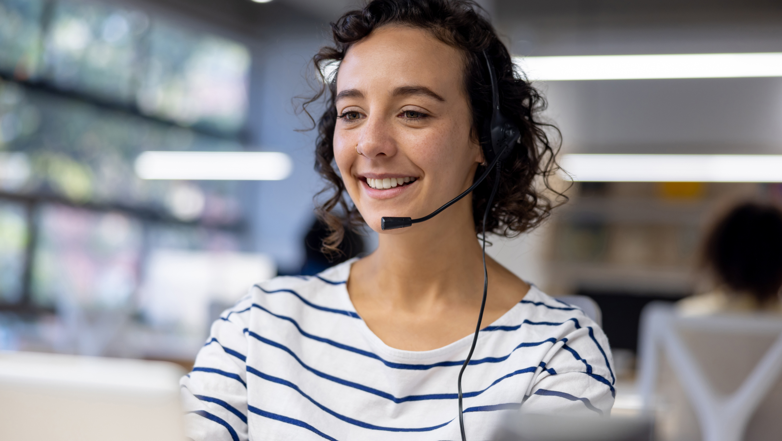 Customer service representative using a headset while working at a call center