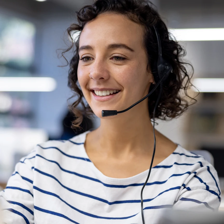 Customer service representative using a headset while working at a call center